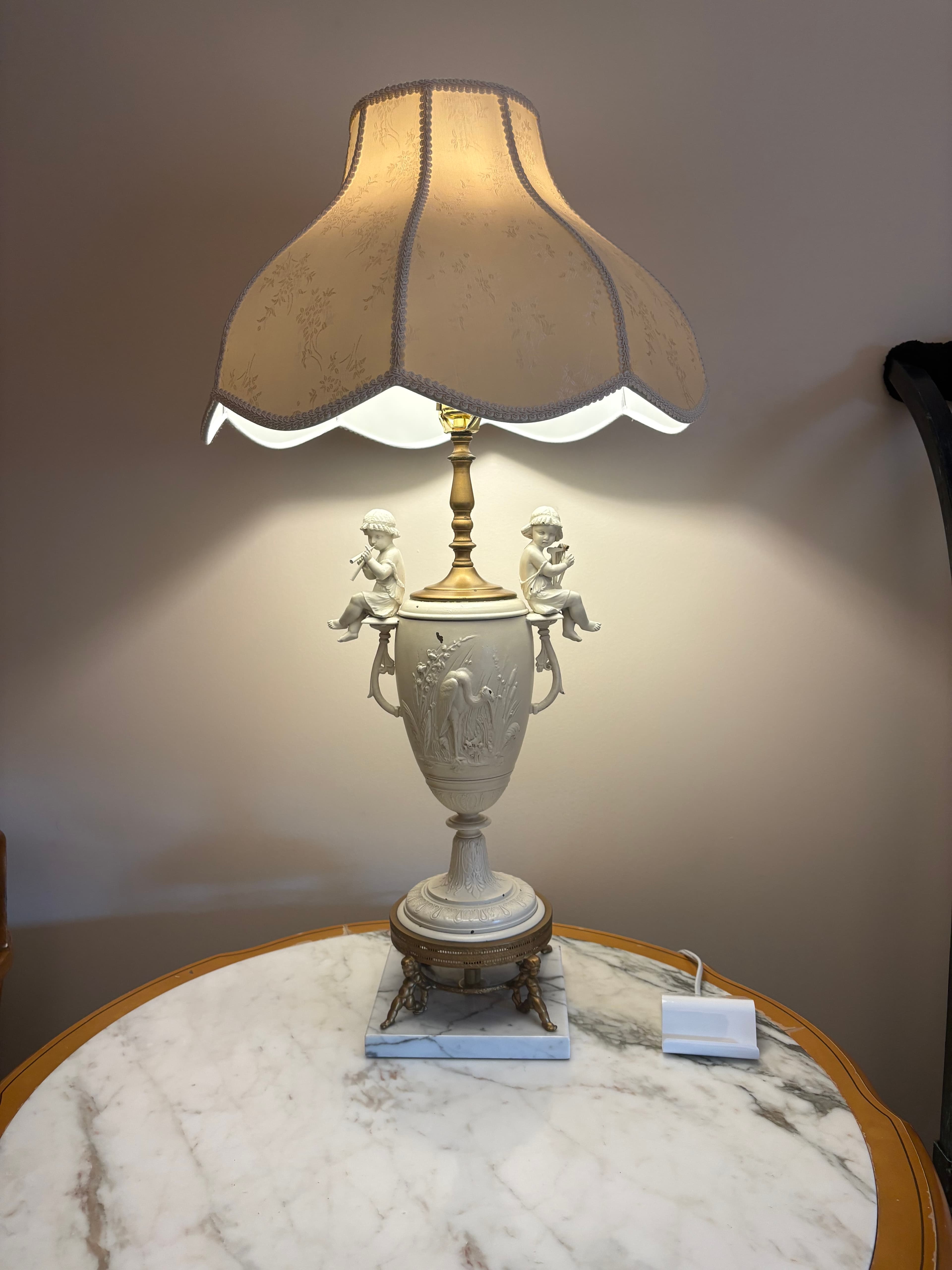 bisque porcelain urn-style lamp on marble topped table, usb outlet near lamb