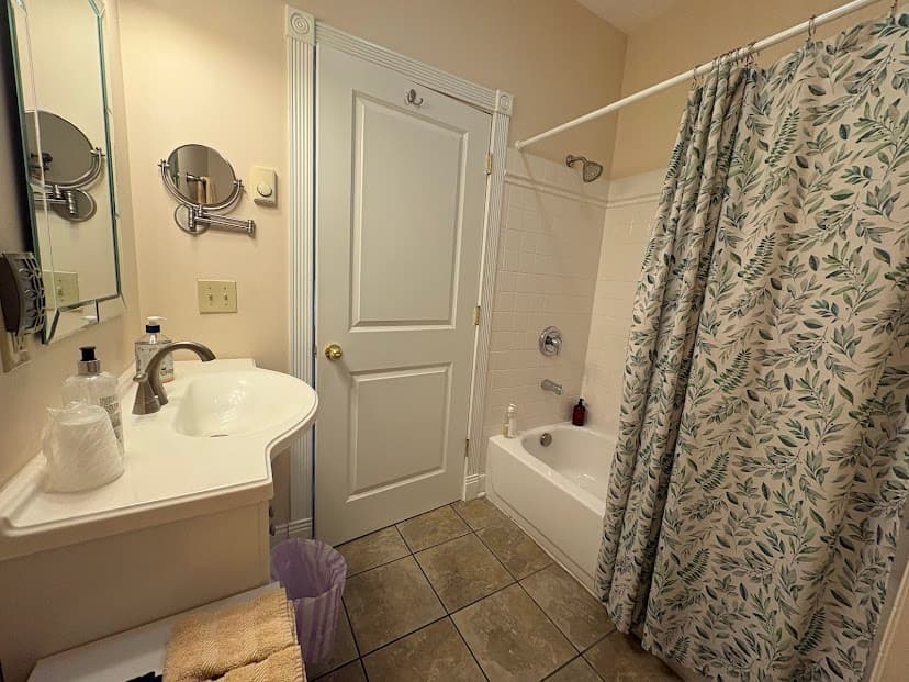 Bathroom showing tub/shower combination, sink and mirror