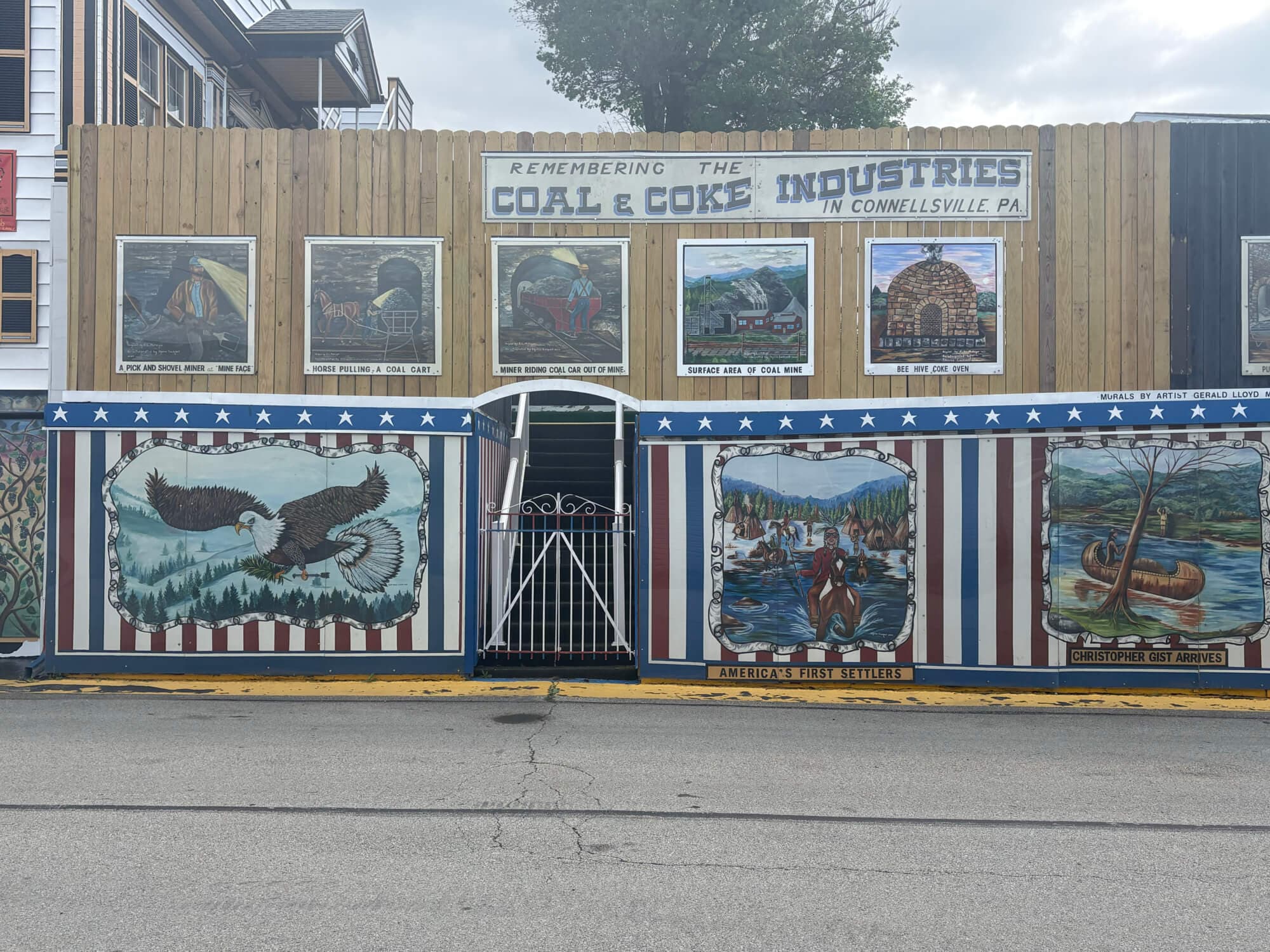 A mural commemorating the coal and coke industries in Connellsville, Pennsylvania, featuring various themed paintings and a decorative entrance.