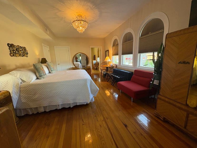 view of king bed, red fulton, round mirror on dressing table
