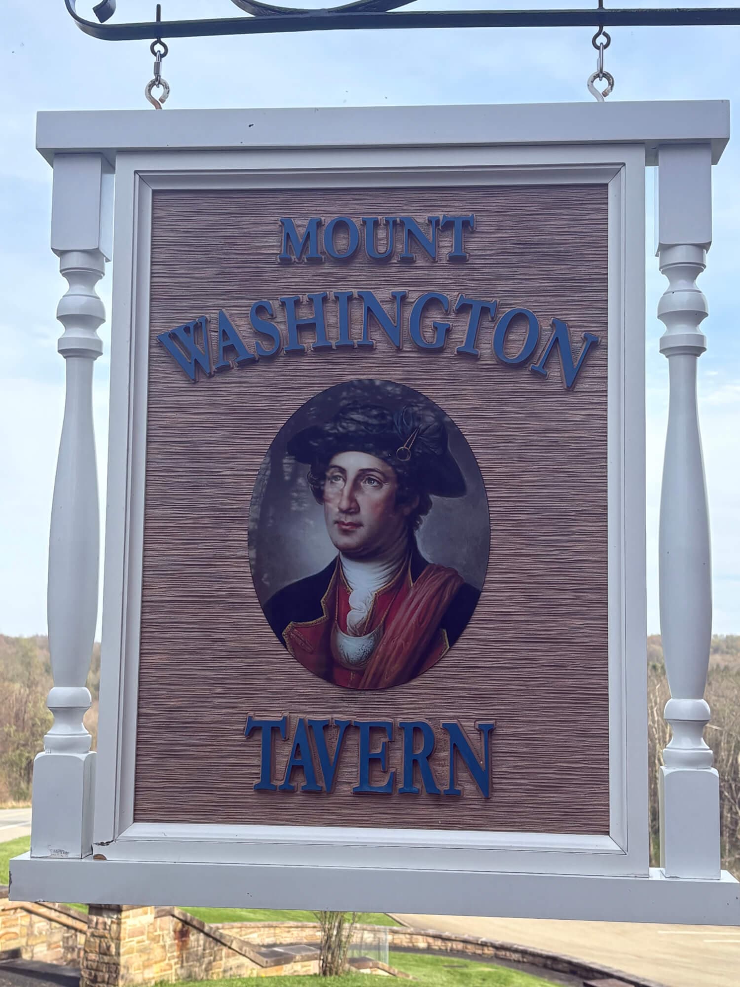 Sign for Mount Washington Tavern featuring an image of a gentleman in historical attire.