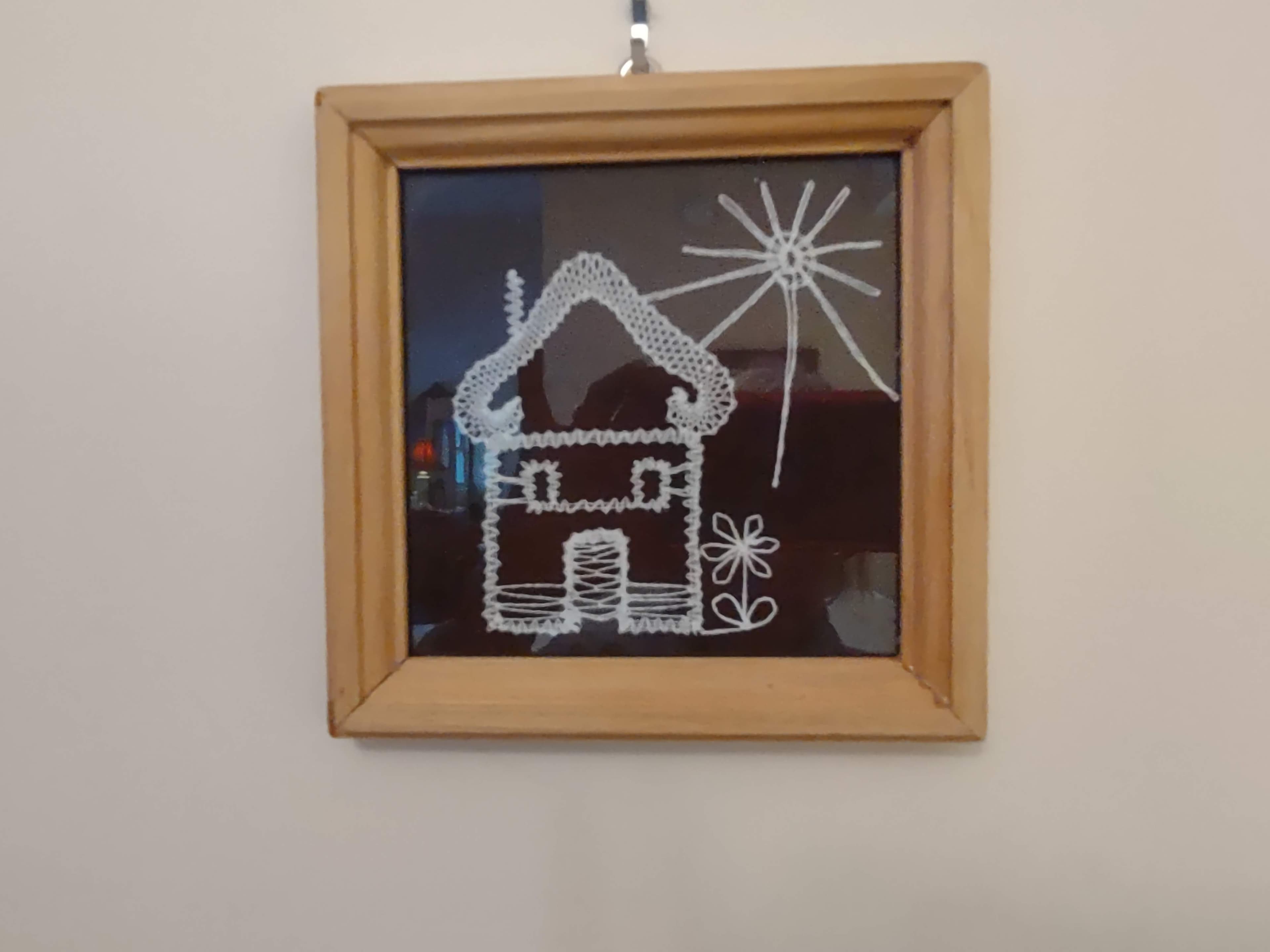 Slovak Folk Art ofWhite thread on black background of house and sunand